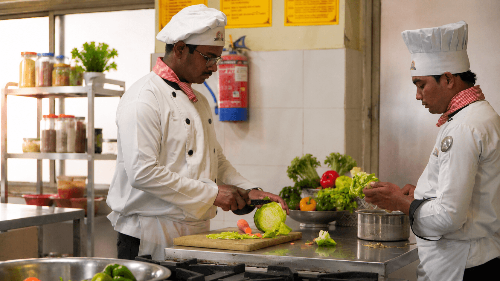 Chef plating a dish in the production kitchen
